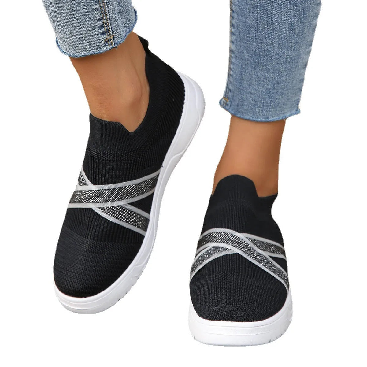Black women's low-top flyknit mesh shoes with flat rubber sole and tassel detail.