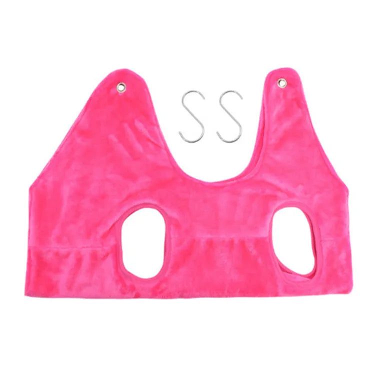 Pet grooming hammock harness in pink with double-layer flannel fabric and reinforced grommets, showing a dog suspended comfortably
