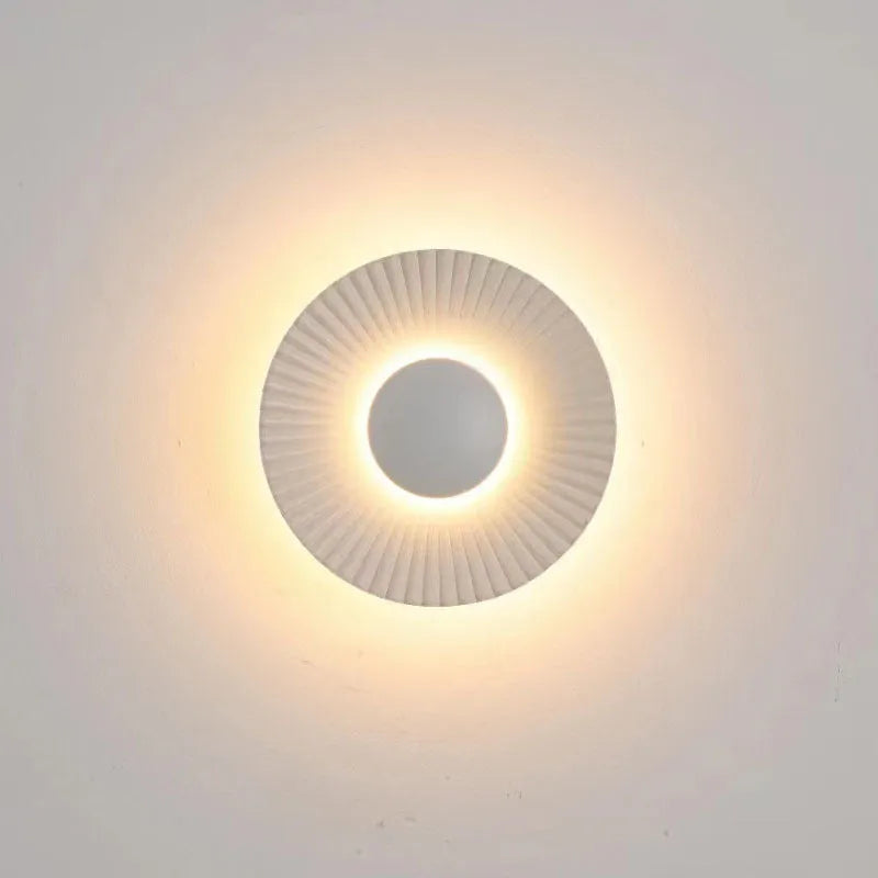 Round aluminium LED wall lamp in a dual-colour finish mounted on a wall.