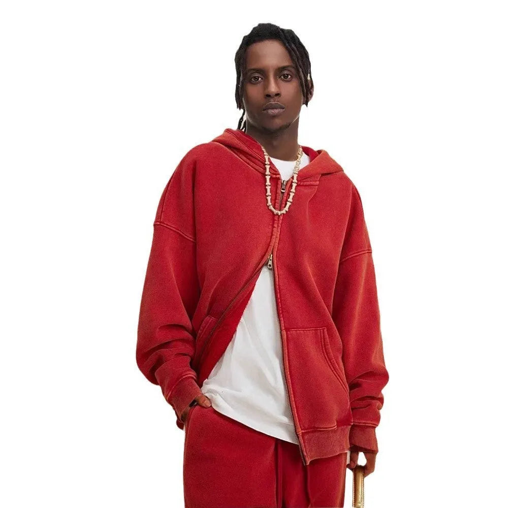 Man wearing a washed black hooded cardigan with a double zipper and fleece lining