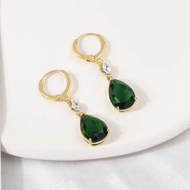 Green geometric teardrop alloy earrings on a white background.