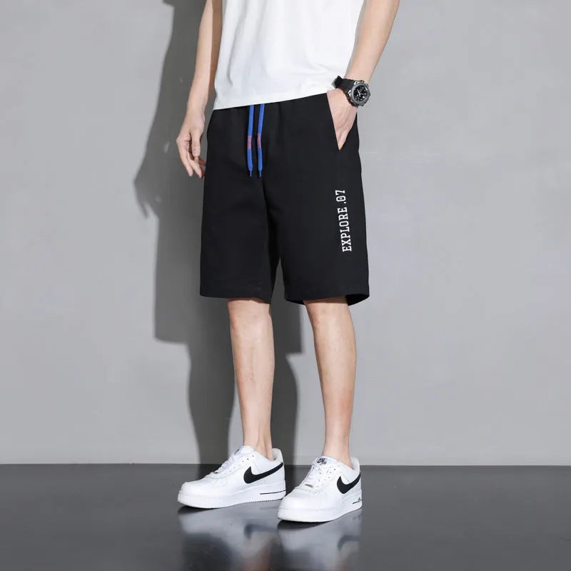 Boys cotton shorts in black, shown in a casual setting for summer.