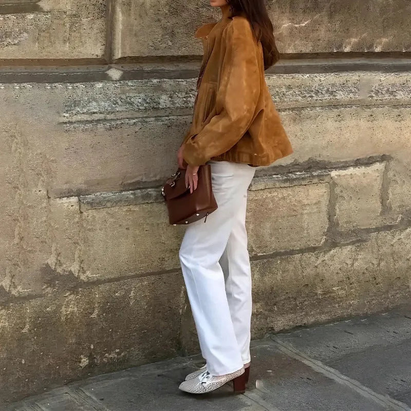 Man wearing a solid colour loose fit retro-style long sleeve polyester jacket.
