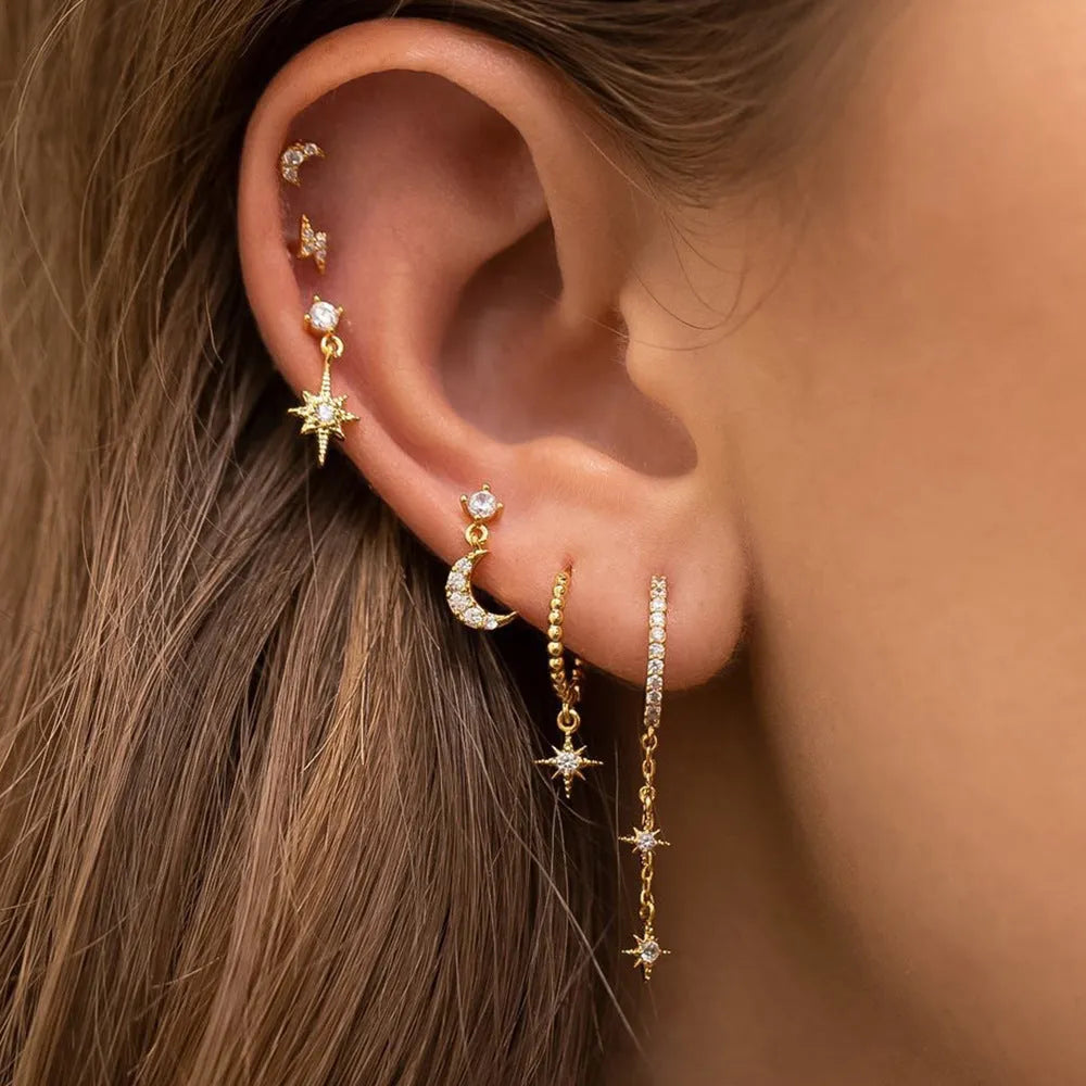 XINGX set of six gold electroplated chain tassel earrings with zircon studs on display