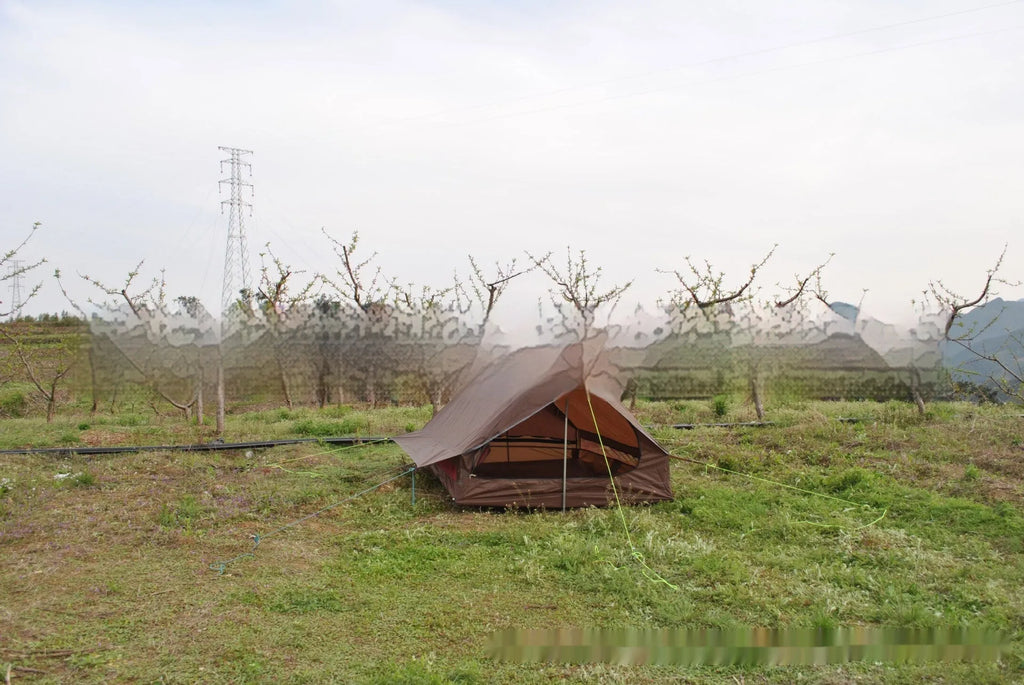 Brown or white A-line hiking tent pitched using hiking canes, showing spacious interior for 2-3 people.