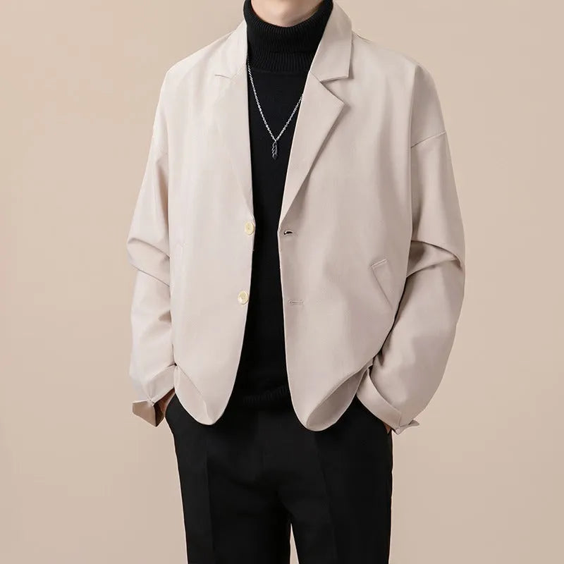 A man's loose fit suit jacket in a chemical fibre blend fabric, shown in one of four available colours.