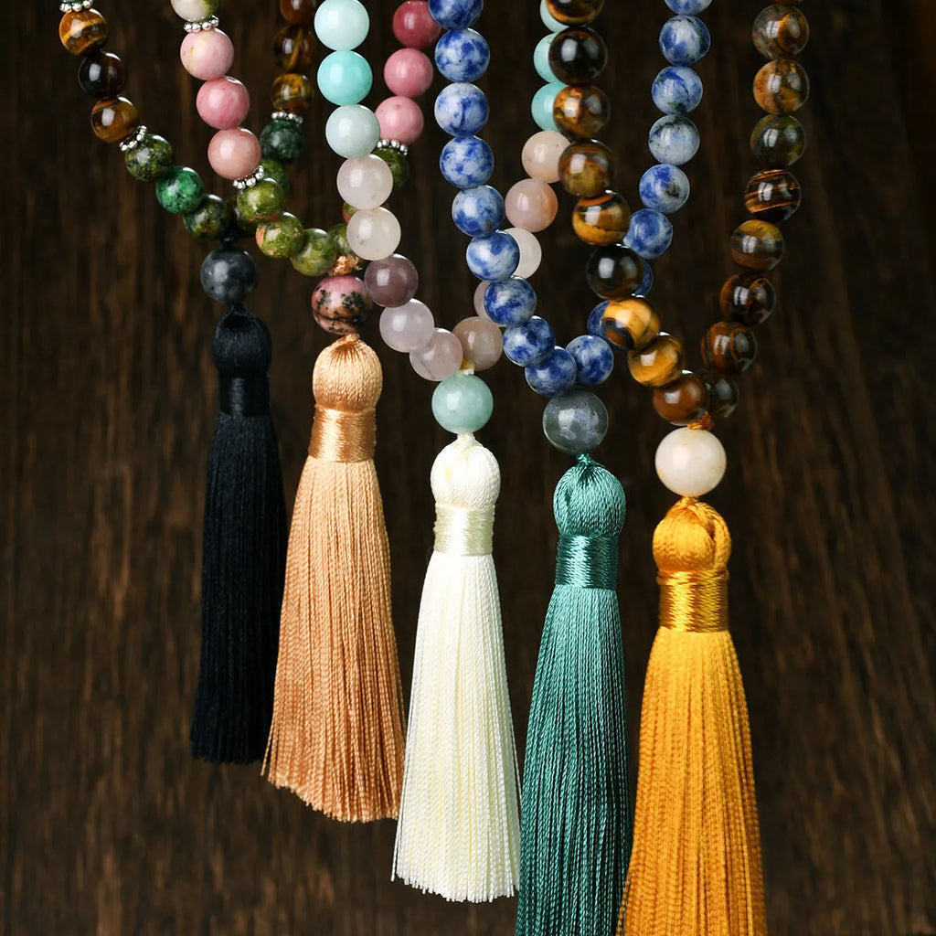 Long bohemian necklace with 108 natural stone beads, a geometric pendant, and a coloured tassel on a ball bead chain.