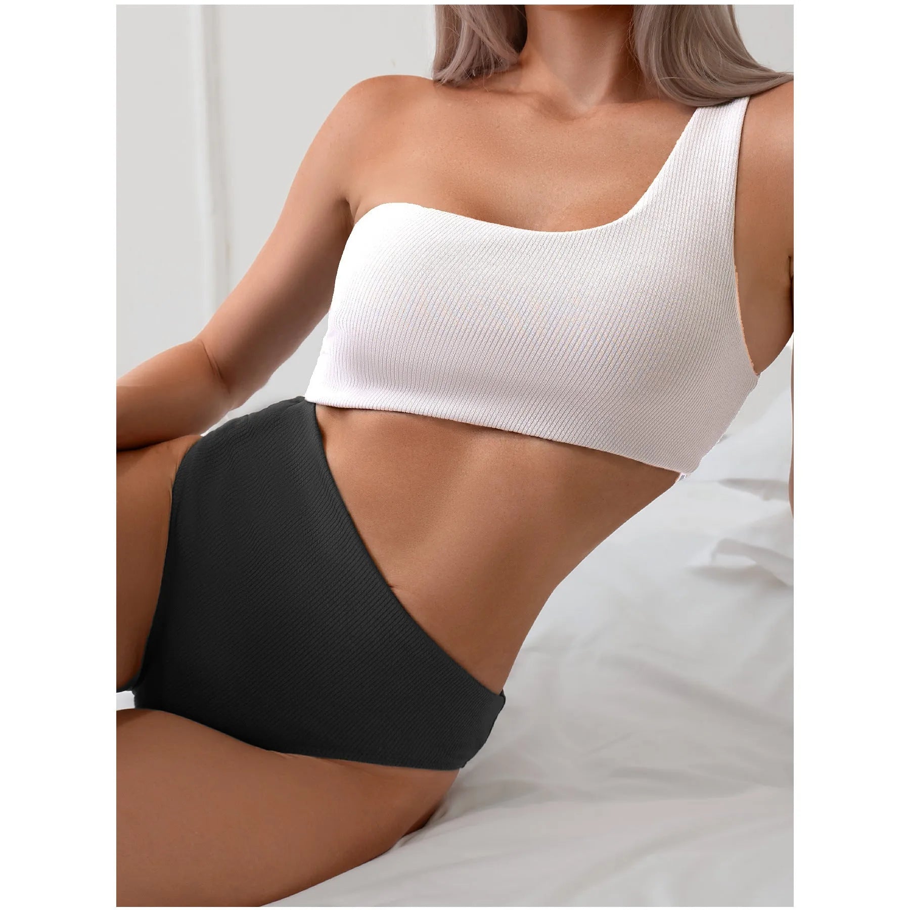 Light grey one-shoulder one-piece swimsuit on a mannequin, solid colour polyester fabric.