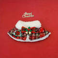 Polyester pet scarf cloak on a dog, showing a red background with a festive snowflake bell design.