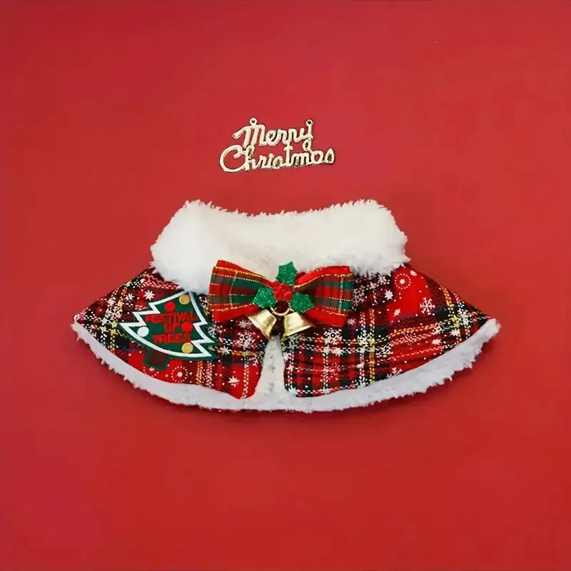 Polyester pet scarf cloak on a dog, showing a red background with a festive snowflake bell design.