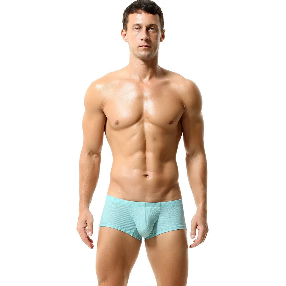 Men's solid colour low-waist nylon boxer shorts on a white background.