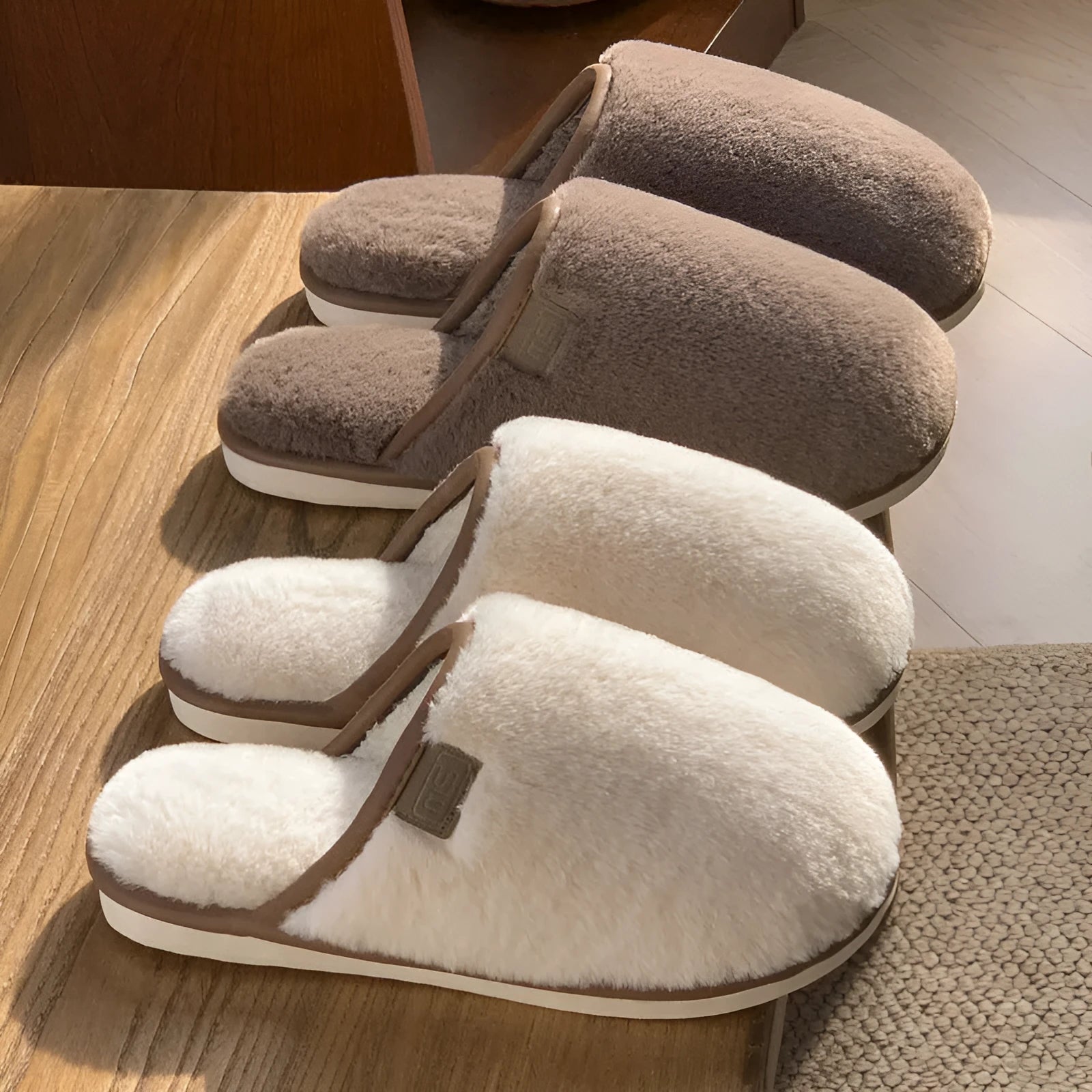 Solid colour PVC plush winter house slippers on a wooden floor.