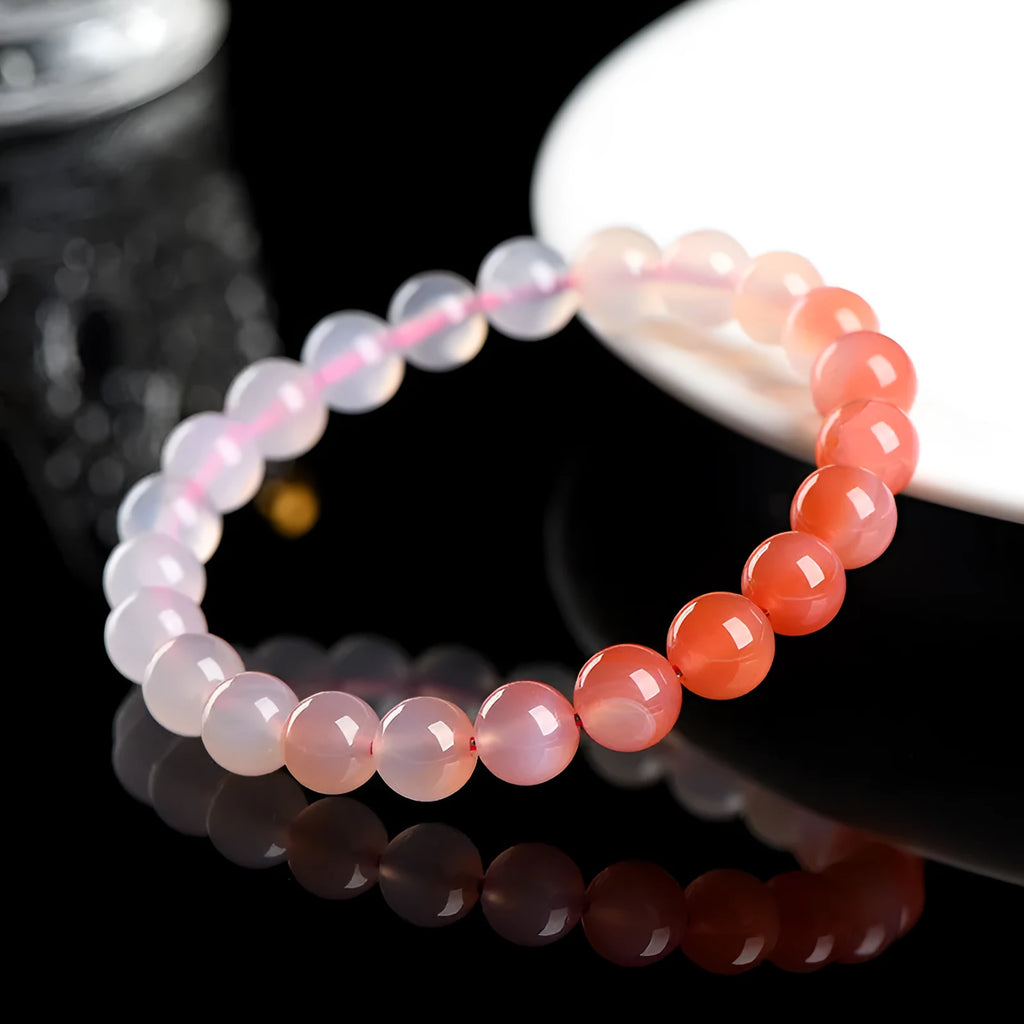 Natural gradient Yanyuan agate beaded bracelet with geometric polished beads on a wrist.