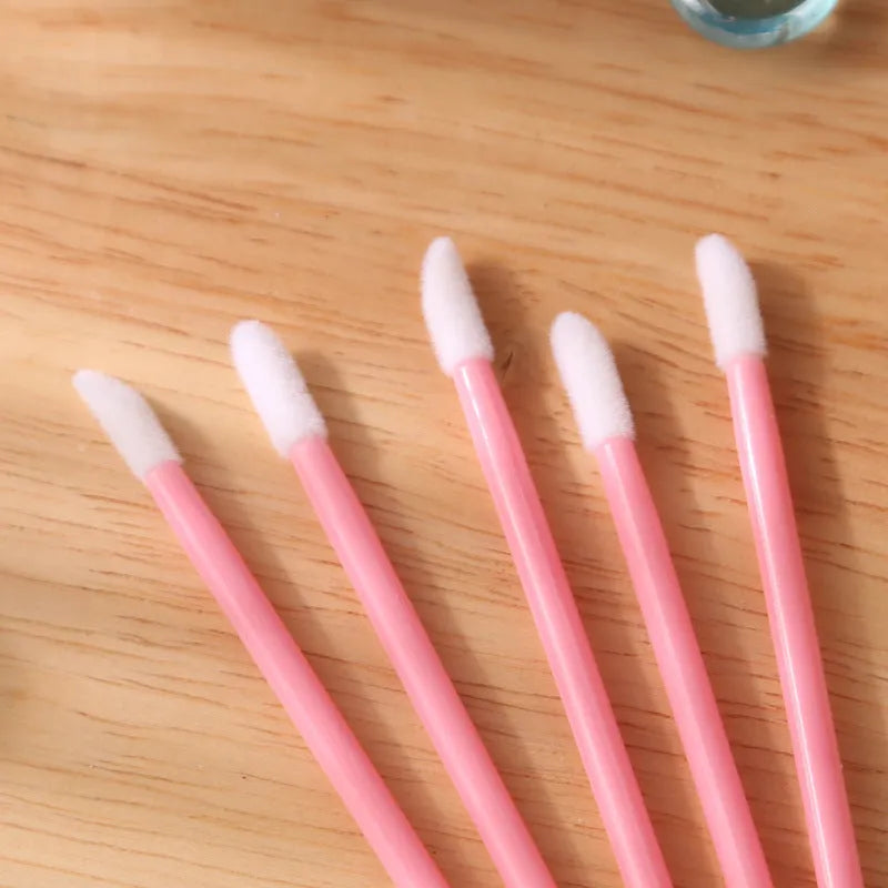 Disposable lip brushes with coloured handles and flocked brush heads for lip makeup application