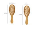 Carbonised bamboo massage comb 66x218mm on neutral background with smooth wooden surface visible