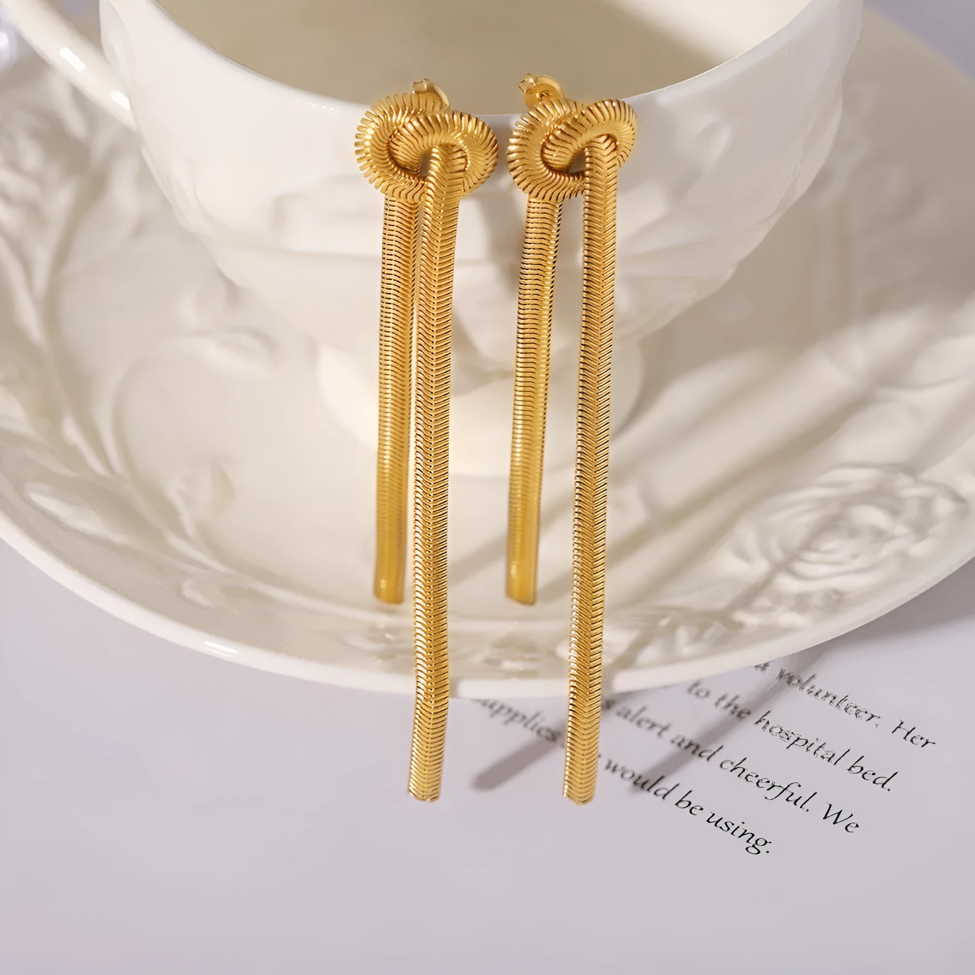 Gold knotted tassel pendant on snake chain necklace with matching earrings
