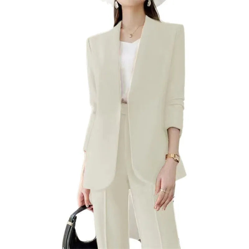 Women's polyester business suit set with blazer and trousers in beige, model standing