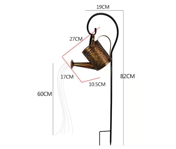 Enchanted watering can solar lamp with warm white star-shaped LED lights in a garden setting