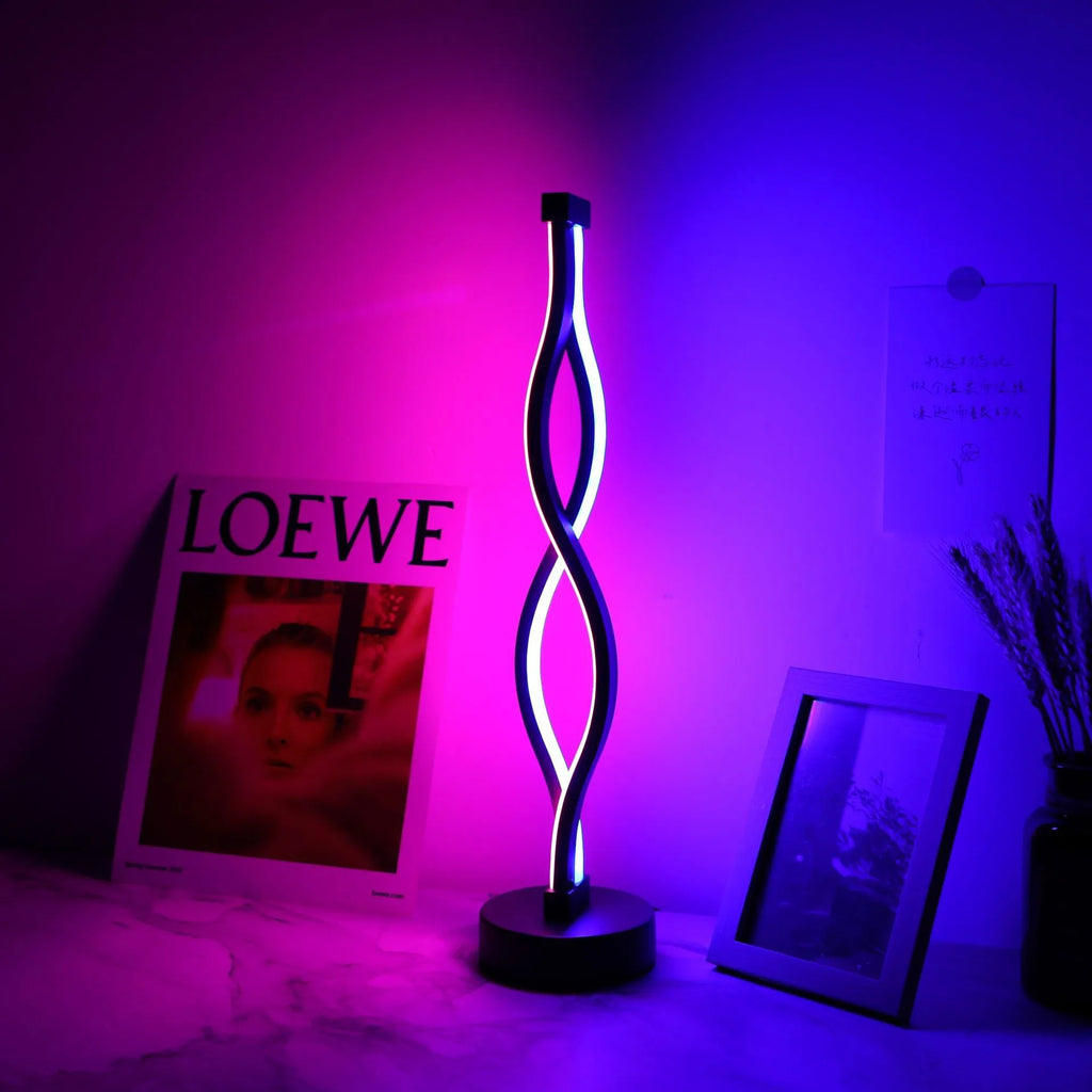 Black aluminium desk lamp with a touch dimming button showing three colour LED lights.
