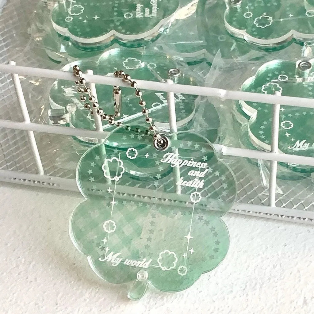 Acrylic four-leaf clover phone pendant keychain on a ring in blue, green, or mint.
