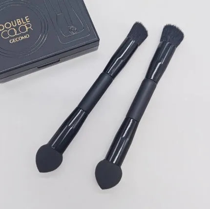Double-headed black makeup brush with a pointed concealer brush on one end and an angled sponge on the other.