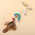 Cat door swing toy with colourful feathers on elastic cord attached by sticky buckle clamp