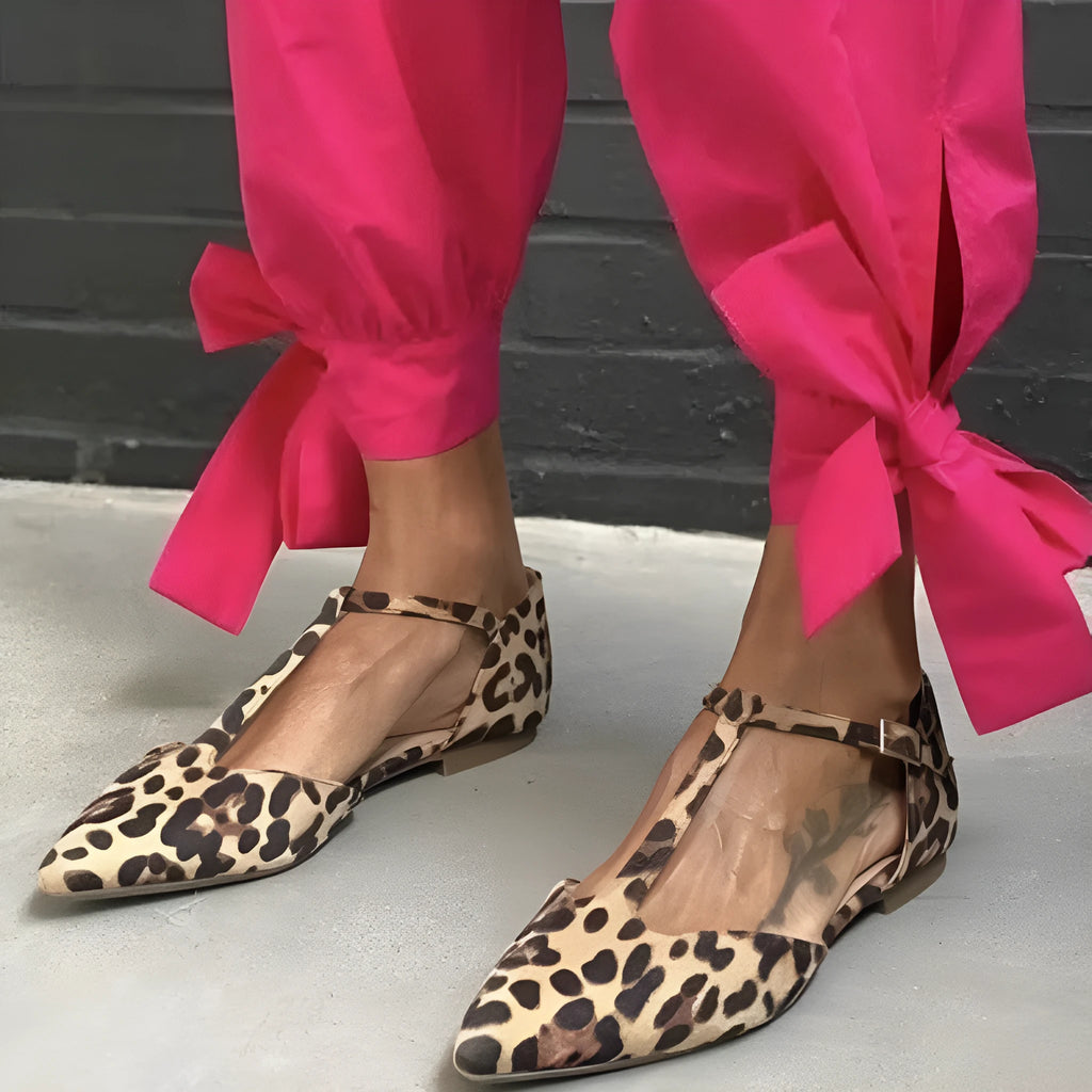 Leopard print women's pumps with pointed toe, chunky low heel, and ankle strap in PU material