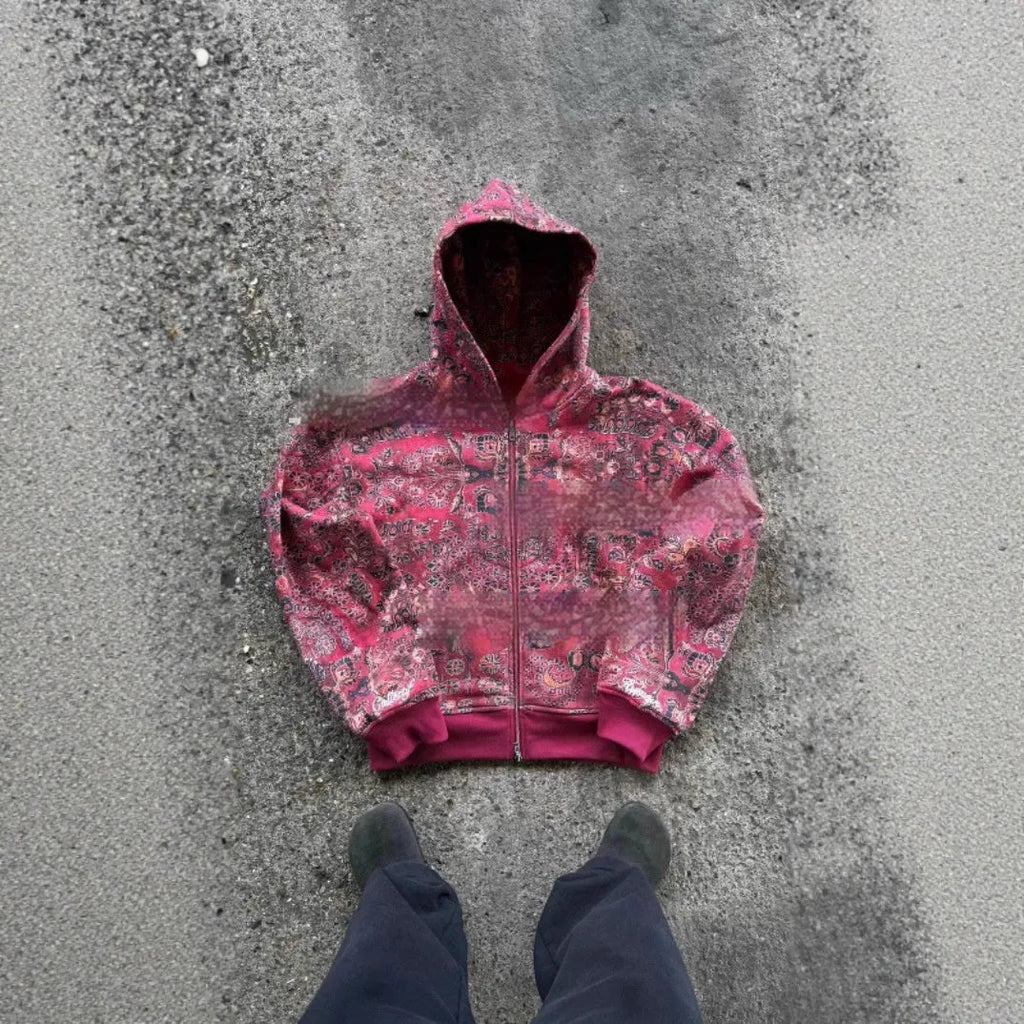 A man wearing a loose-fitting red hooded zip-up coat, casual autumn jacket style.