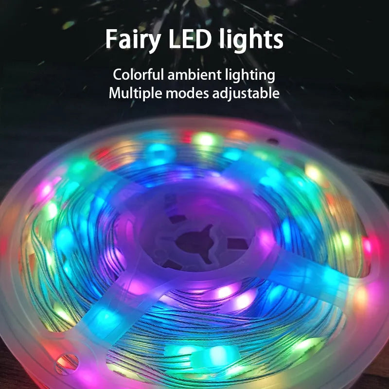 10 metre long multicolour LED party light string with 100 lights coiled on a table next to its control switch.