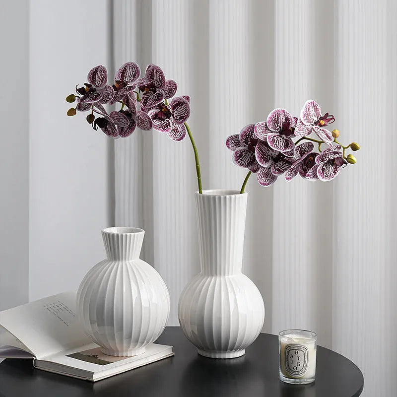 White ceramic ball vase with striped patterning in American country style on wooden table