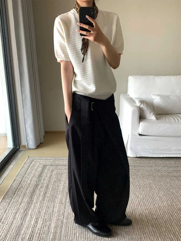 Black straight-leg trousers with a single pleat front and an adjustable waistband, laid flat.