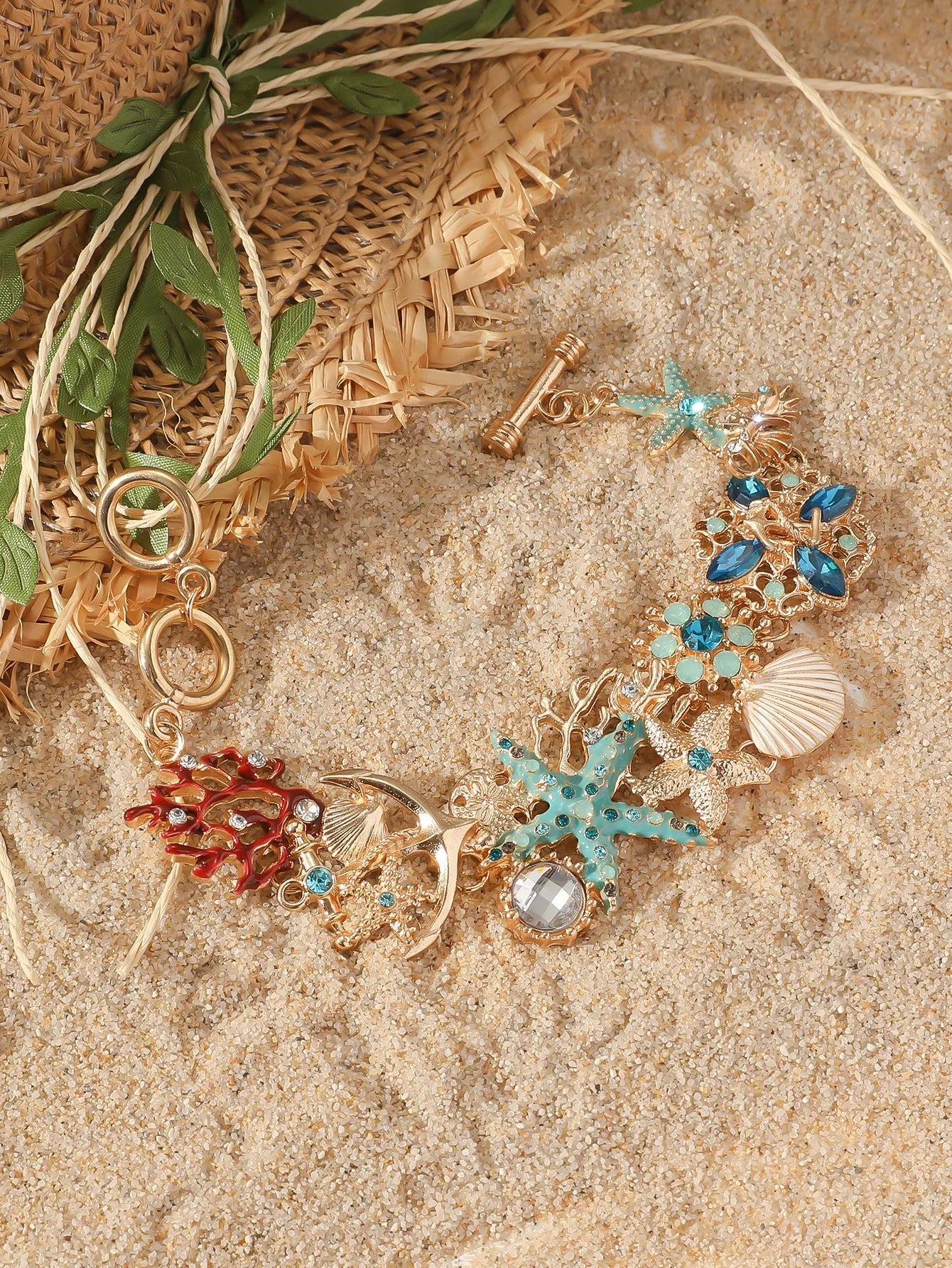 Women's alloy rhinestone bracelet with a nautical boat anchor and starfish design in blue coral colour.