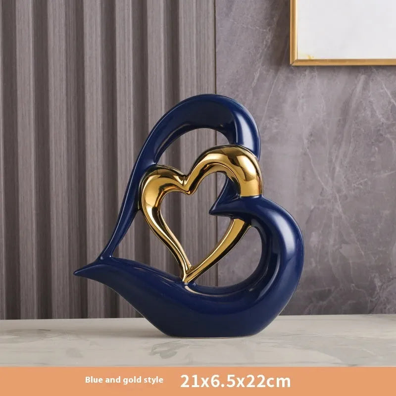 Modern white porcelain heart ornament in a metallic finish, showing its geometric shape on a table.