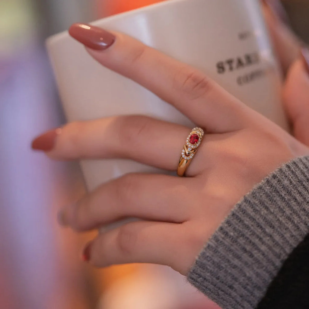 S925 sterling silver ring in yellow gold with geometry shape and diamond treatment on a plain background