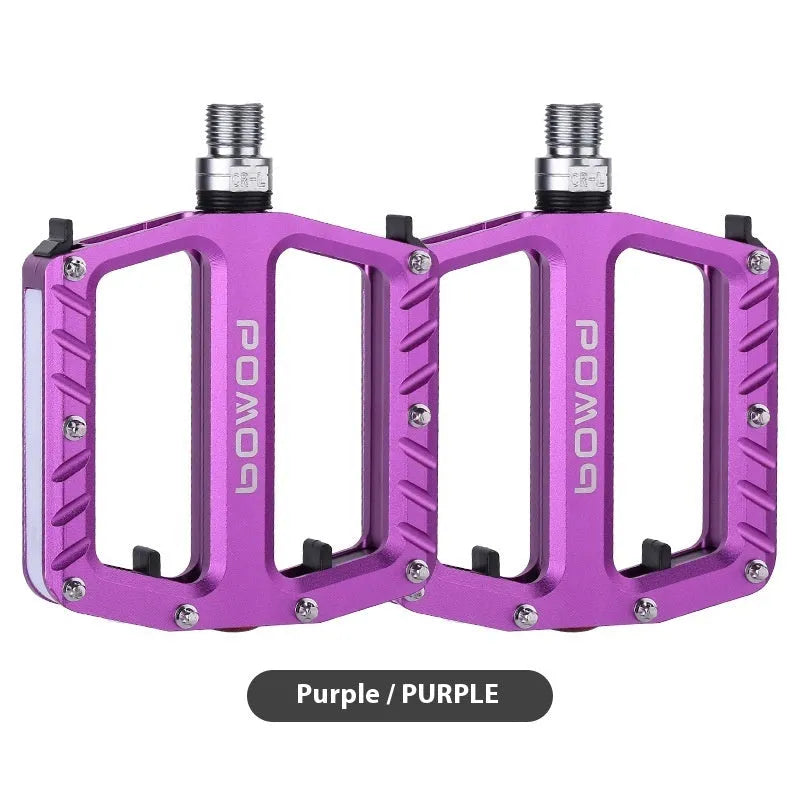 Bicycle pedals with LED lights in purple, black, titanium, red, and gold colour options