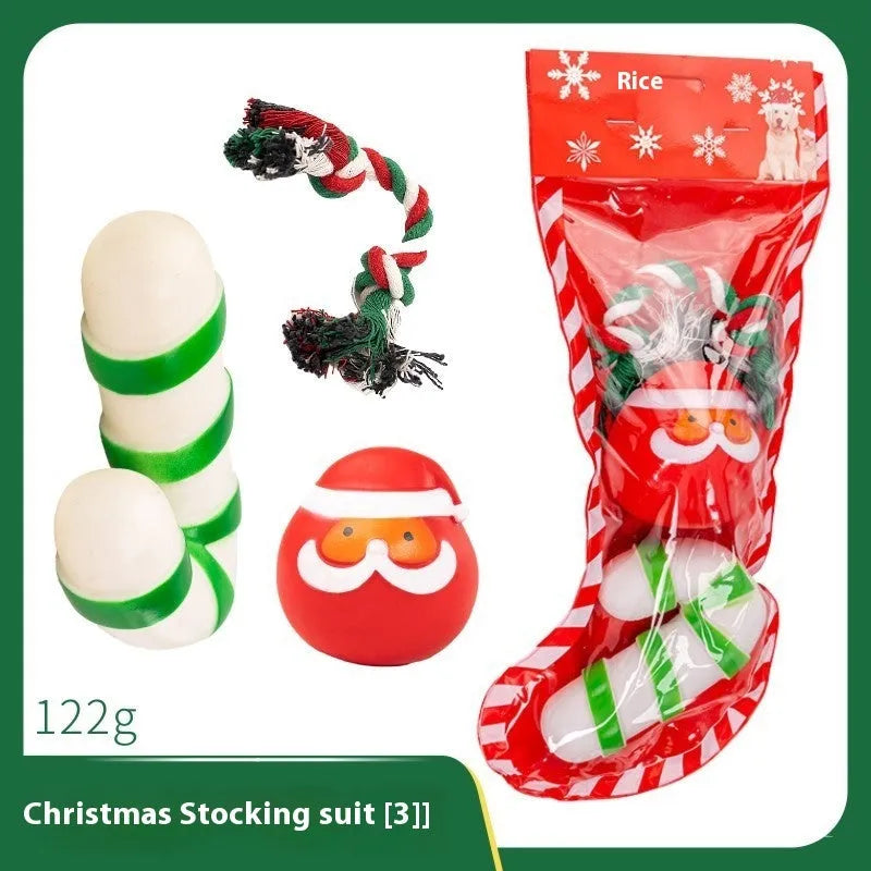 Christmas-themed vinyl dog toys including barbell, ball, rope, and Santa designs in gift packaging