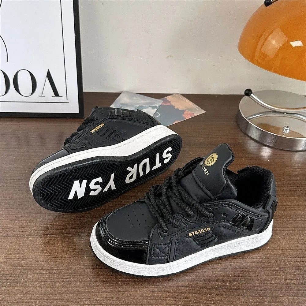 Men's black PU leather round toe board shoes with thick rubber sole on plain background