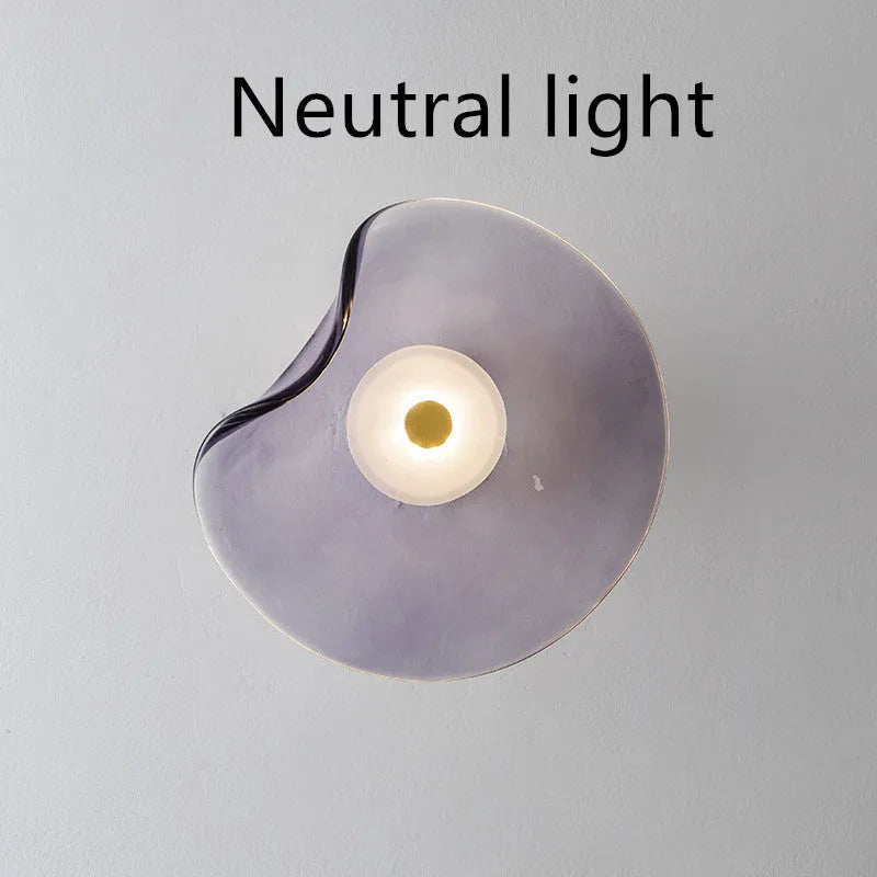 Round glass bedside wall lamp in cognac, light purple, or smoky grey colour.