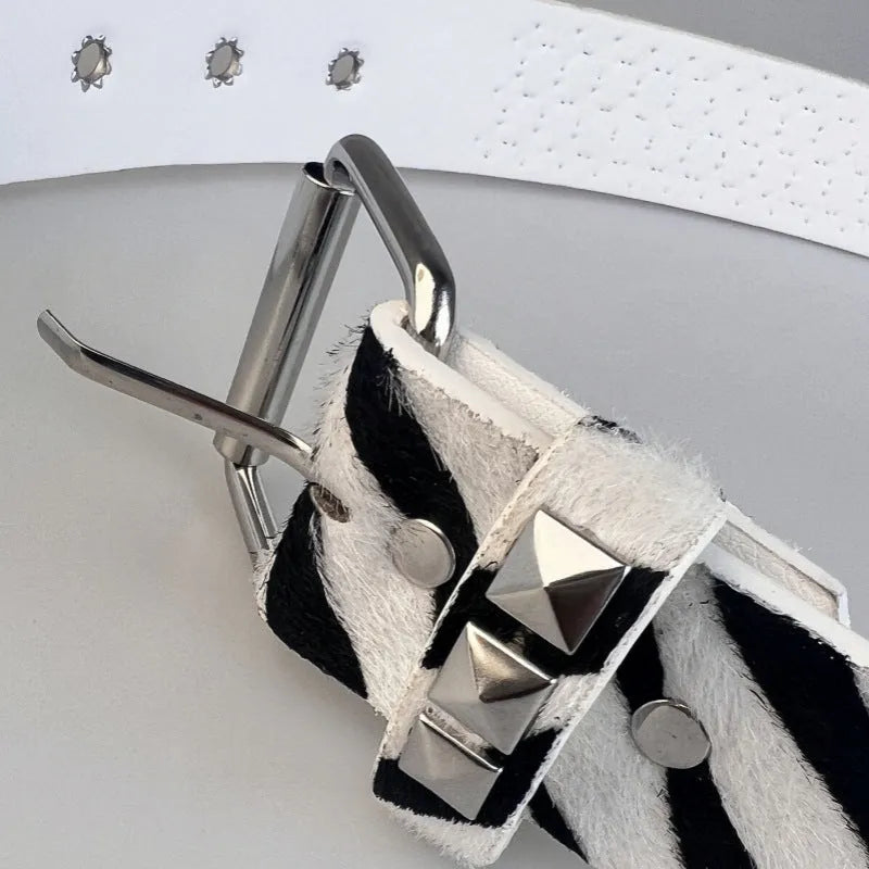 Women's punk fashion belt with metal pyramid studs in leopard print pattern, showing alloy buckle and PU leather strap.