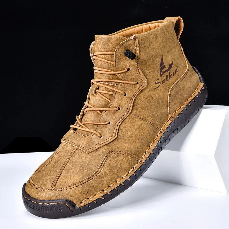 Casual high-top leather boots with elastic band closure and flat heel in beige colour with visible sewing detailing