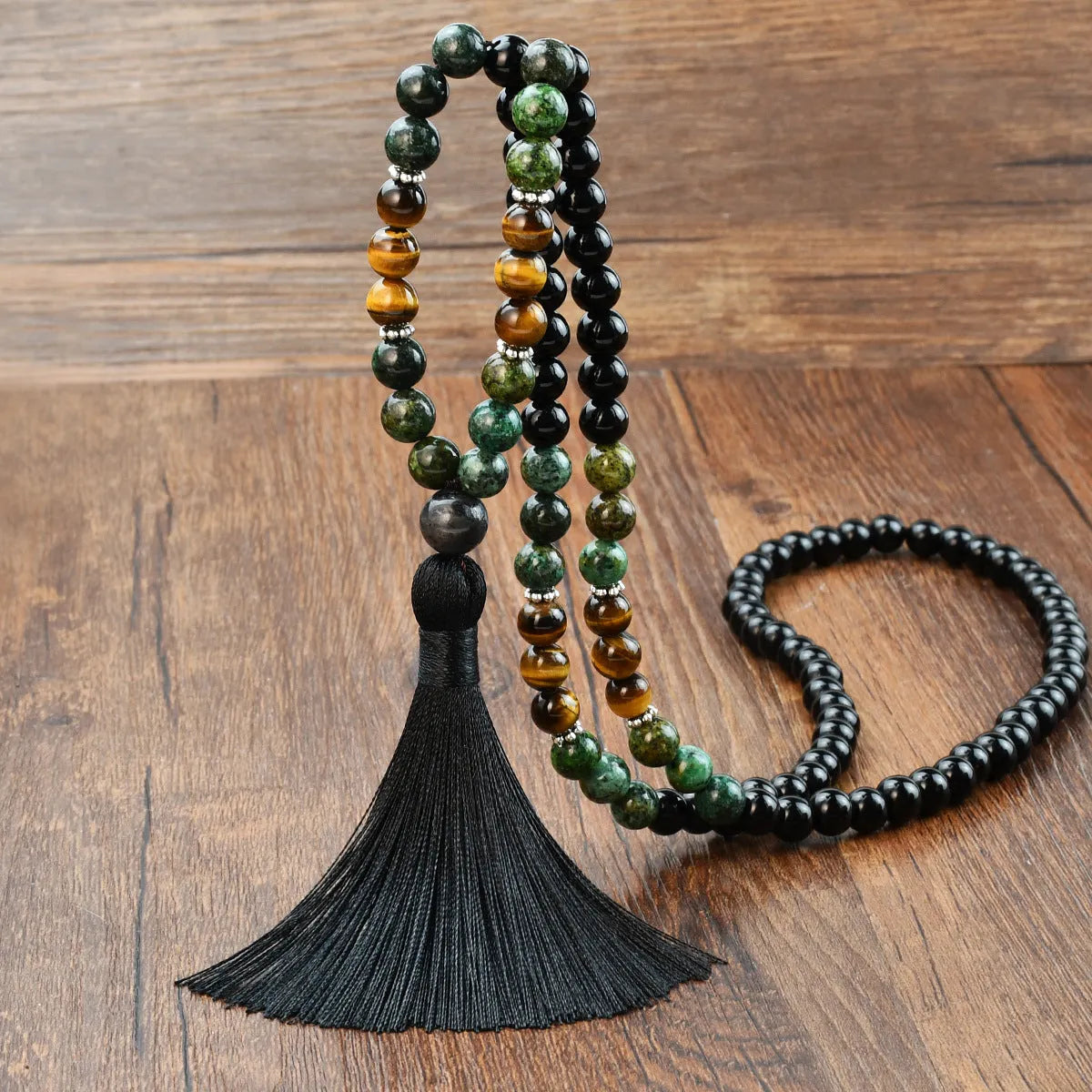 Long bohemian necklace with 108 natural stone beads, a geometric pendant, and a coloured tassel on a ball bead chain.