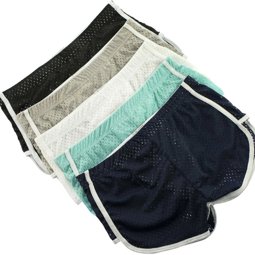 Men's solid colour boxer shorts in a cotton and nylon fabric blend, shown in black, on a mid-waist fit model.