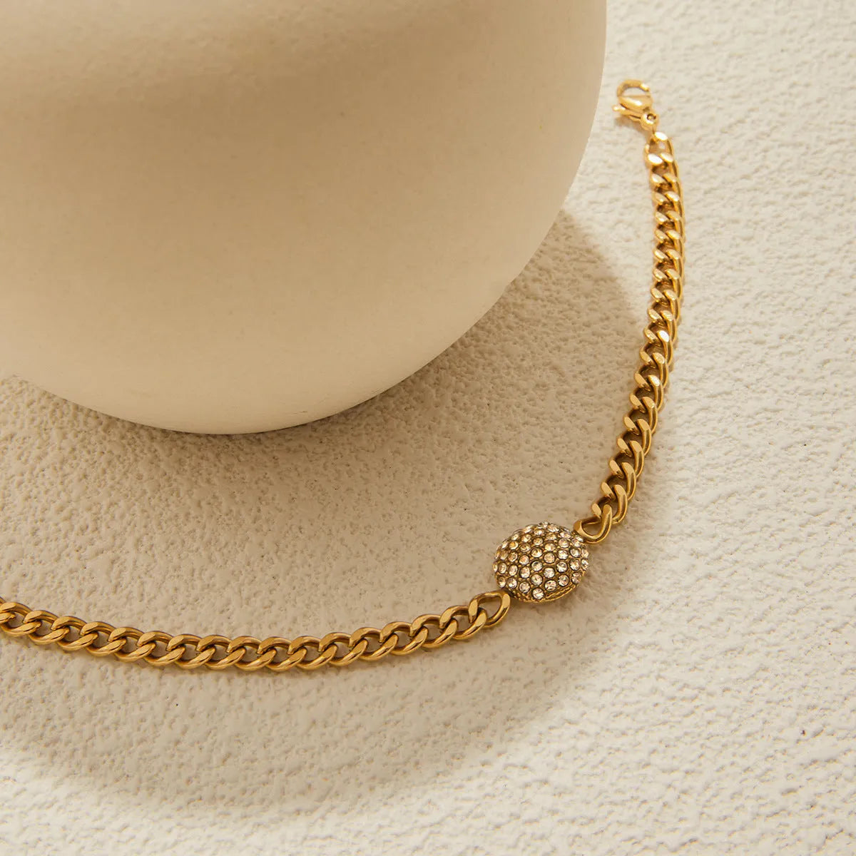 Stainless steel electroplated geometric round link bracelet for women on white background