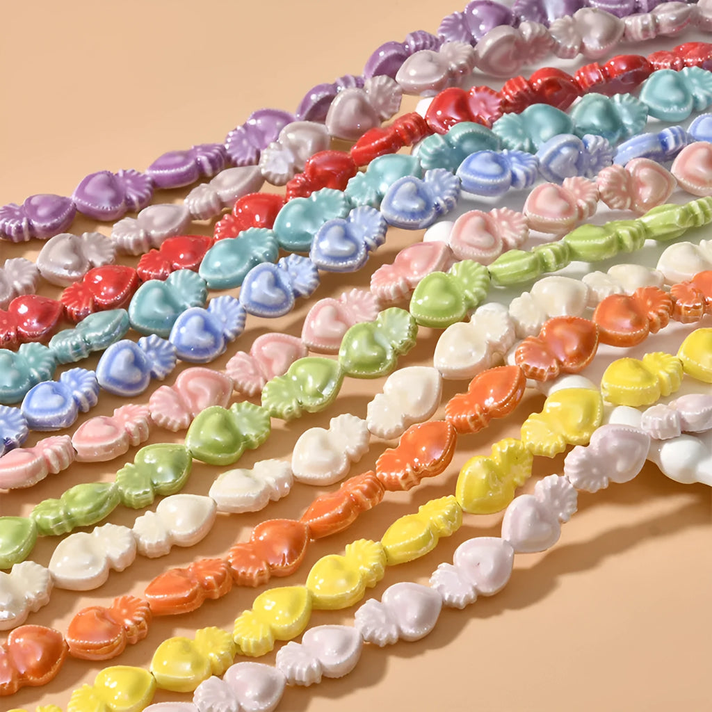 Ceramic heart torch beads in various colours for jewellery making, approximately 10mm by 15mm with straight hole