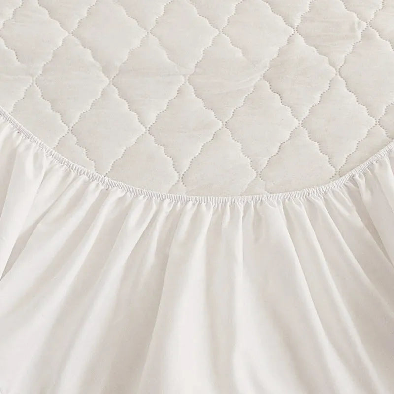 Diamond lattice quilted waterproof mattress protector and pillowcases in a solid colour.