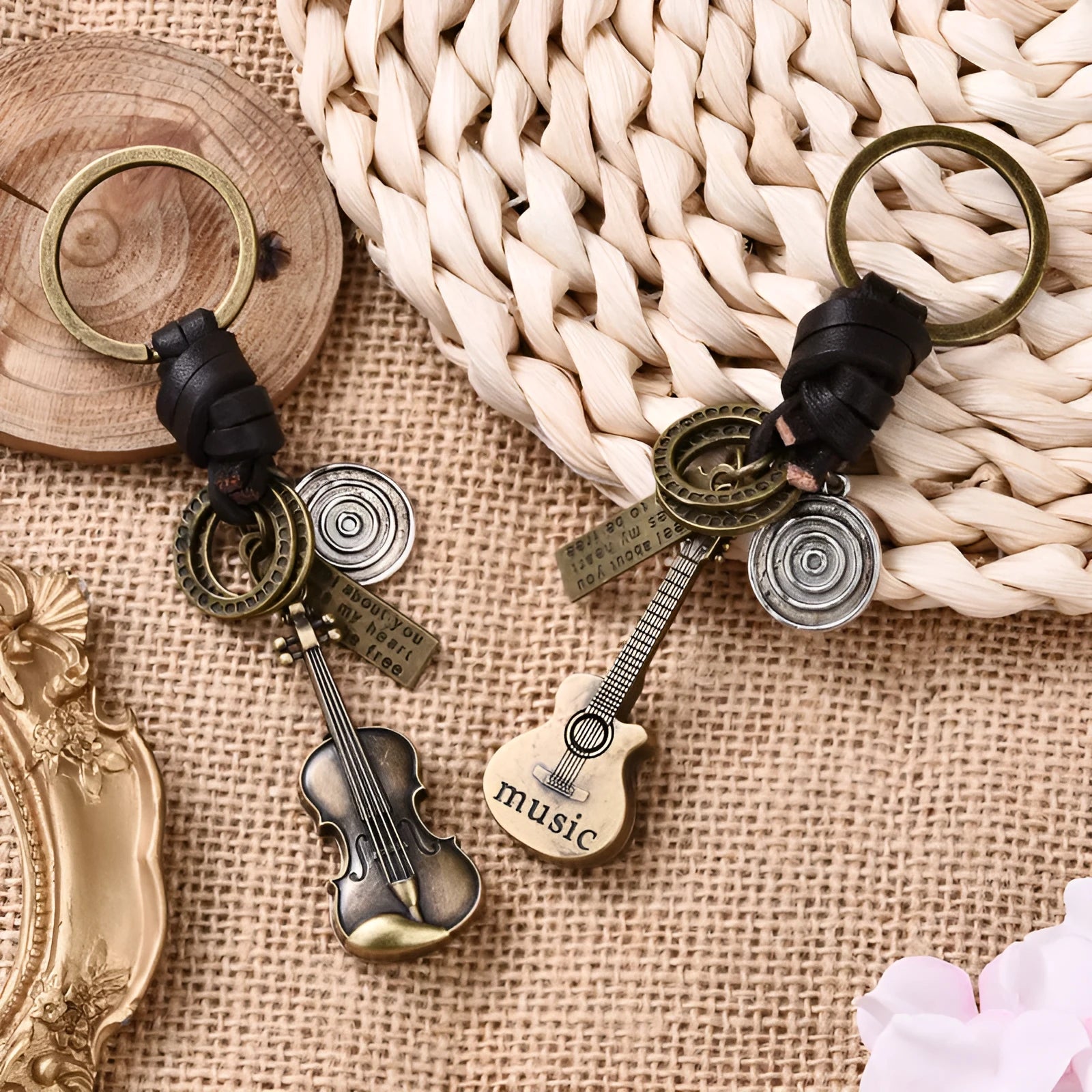 Retro guitar keychain pendant with woven cowhide charm and electroplated alloy finish on white background