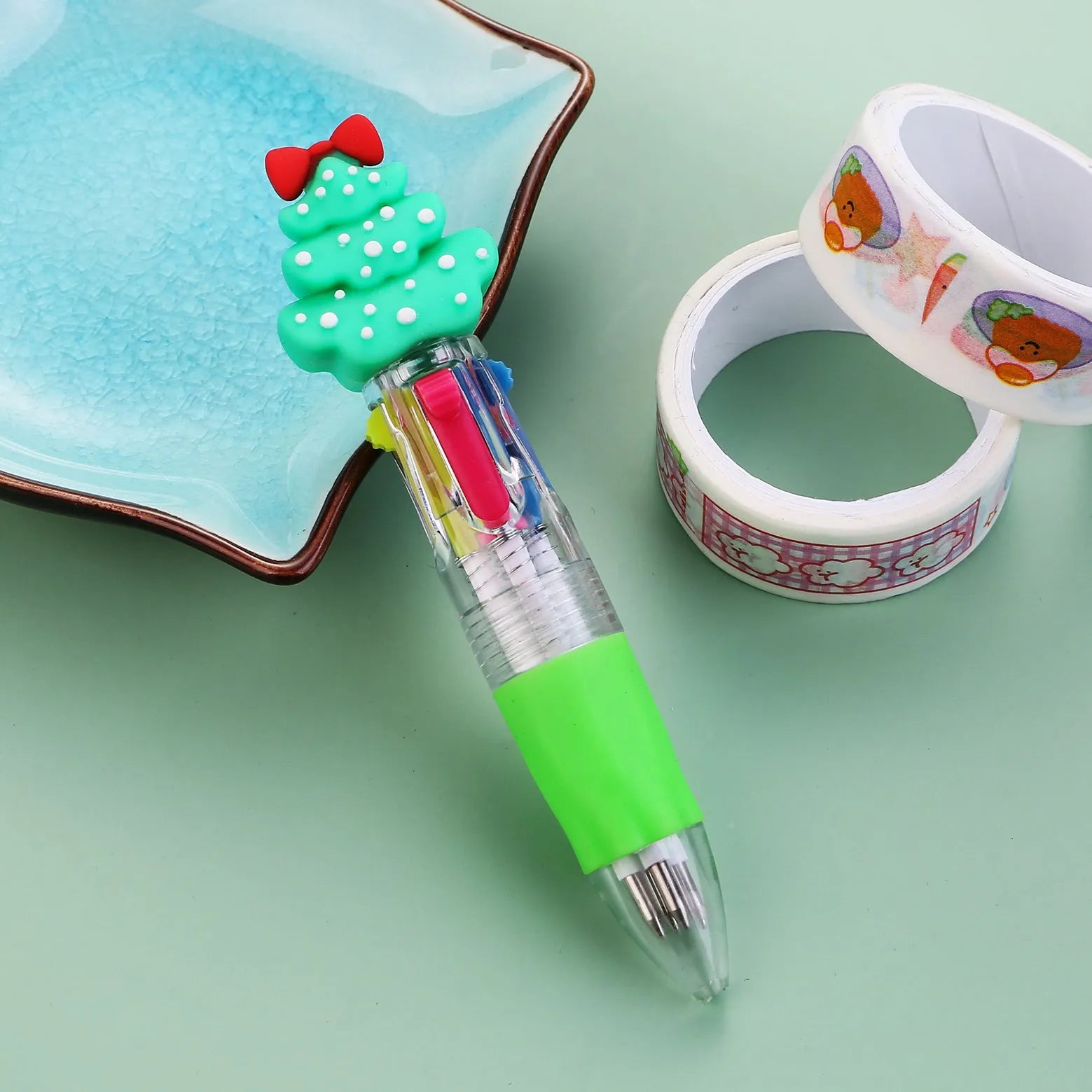 Compact 11cm Christmas-themed press-action ballpoint pen with festive designs.