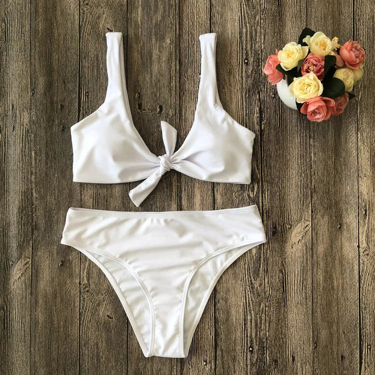 Women's solid colour bikini set showing bra top and matching panties in polyester fabric
