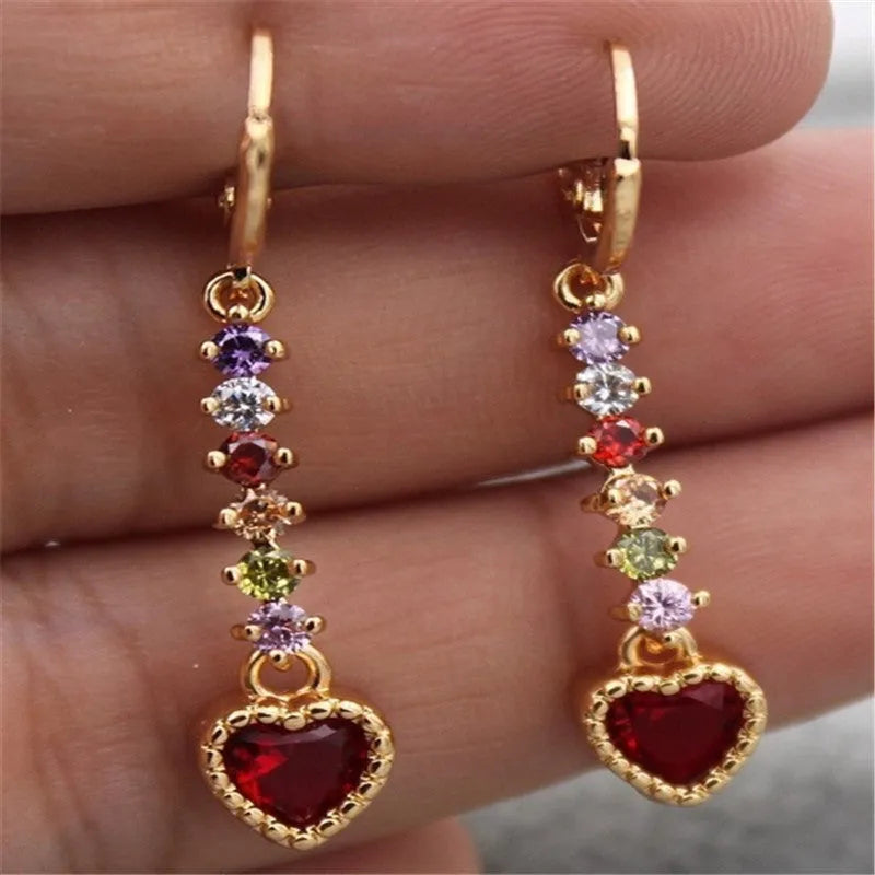 A pair of women's heart-shaped fashion earrings in a gold or silver alloy metal finish.