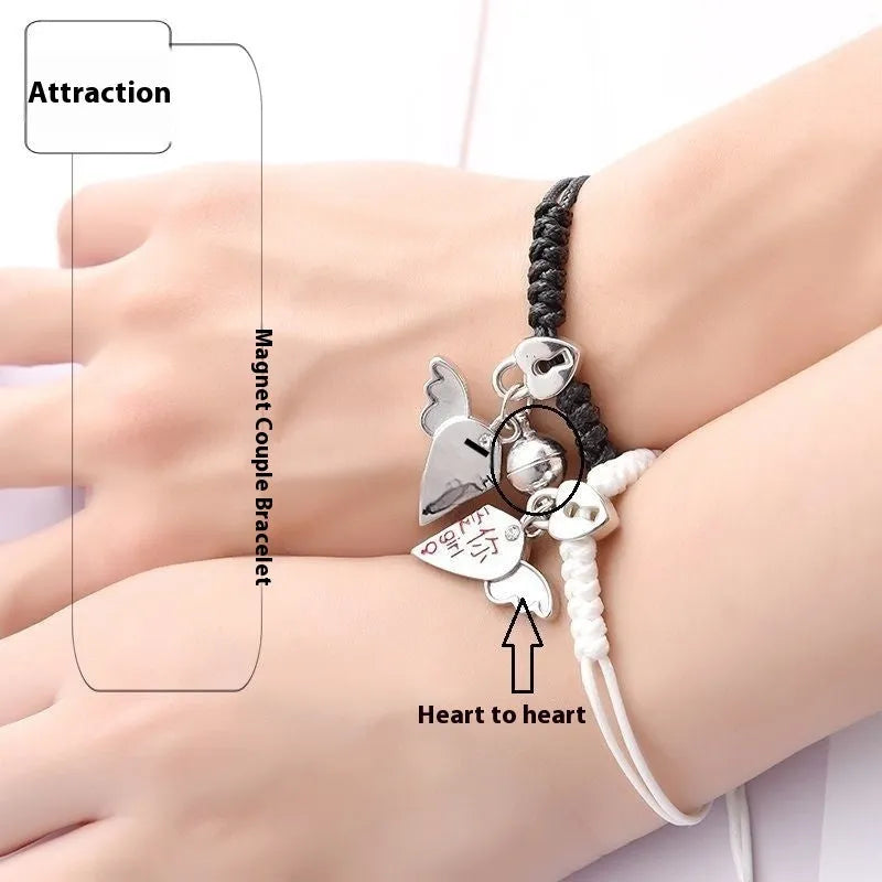 Pair of magnetic suction bracelets with alloy charms in various love and friendship themed designs on a wrist.